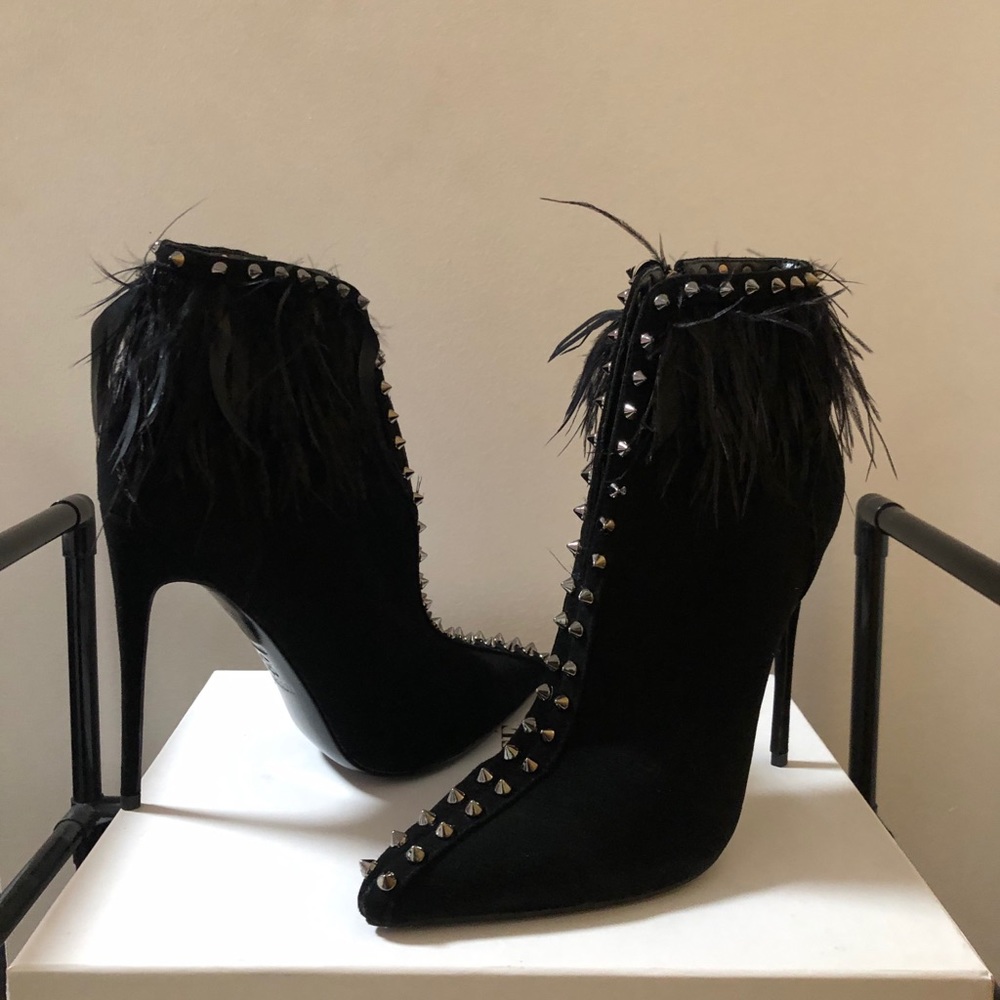 Black suede bootie lined with ostrich feathers and spikes.